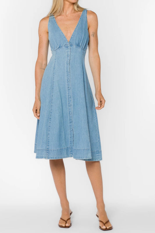 Woman wearing a light blue dress against a white background